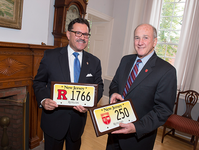 President Barchi and Raymond Martinez, chief administrator of the New Jersey Motor Vehicle Commission, with specialized license plates honoring Rutgers’ 250th anniversary